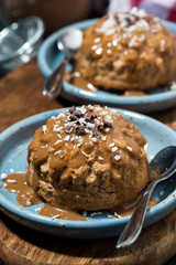 chocolate portioned cheesecake with caramel sauce on plate, vertical