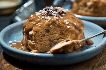chocolate portioned cheesecake with caramel sauce on plate, closeup