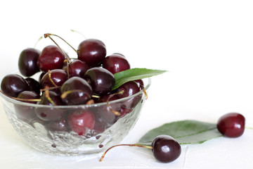 cherry fruit in glass bowl on white background.