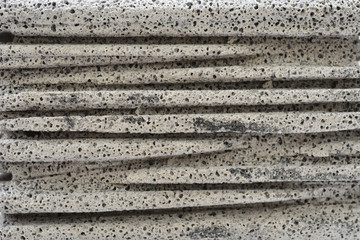 Concrete surface is broken and eroded horizontally.