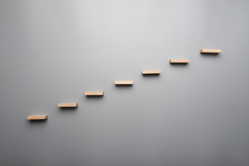 Graph or wooden steps on grey background in a concept of vision