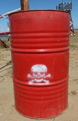 Fototapeta na wymiar red barrel with dangerous cargo: chemicals, toxic waste materials or poison