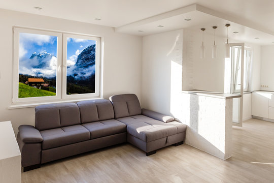 Living room with wide big windows typical for mountain style