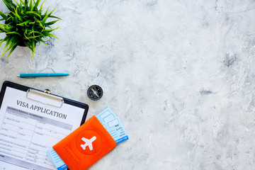 Planning vacation. Visa prosessing. Airplane tickets near passport cover with airplane silhouette, visa application form, compas on grey background top view copy space © 9dreamstudio
