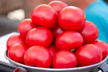 Fresh appetizing pink tomatoes, laid out on the counter by the seller on the market