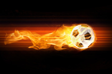 Klassischer Fußball aus Leder brennt mit Feuerschweif und Funken auf modernem Hintergrund © chrisre