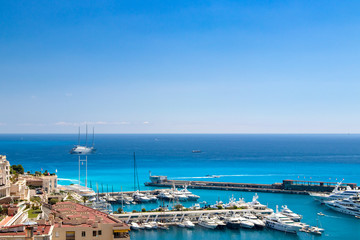 Fototapeta premium Many motor yachts docked in Fontvielle harbour on a sunny day, Monaco.