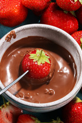 Fondue with Melting chocolate or melted chocolate and strawberry.
