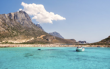 Obraz premium Balos Lagoon Blue sea, hills and boat, transparent water as a swimming pool, Crete Island, Greece