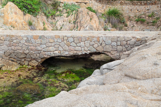 old stone bridge at the foot of the mountain