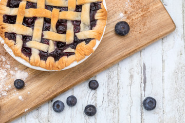 Homemade small individual blueberry pies with fresh summer blueberries