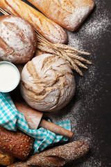Various crusty bread and cup of milk