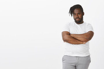 Not sure if friend telling truth. Portrait of suspicious and doubtful dark-skinned fat guy,...