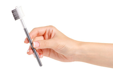 Brush for eyebrows in hands on a white background Isolation