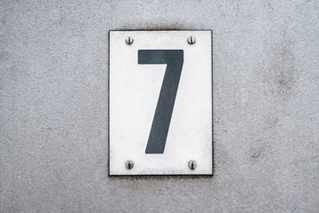 Number 7 / seven on metal background / house number -