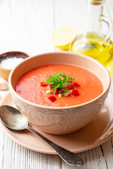 Gazpacho soup in bowl on white wooden background. Traditional spanish dish.
