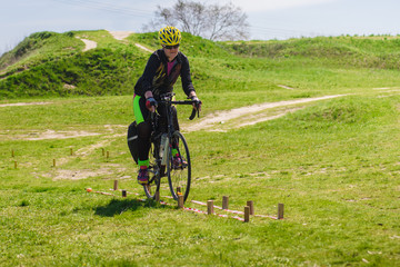 Young female biker participating in cycling tourism competition