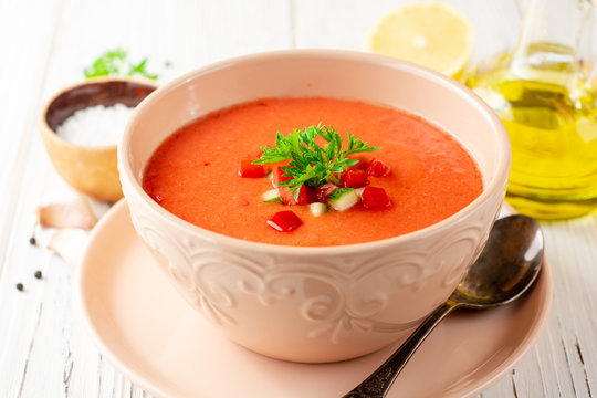Gazpacho soup in bowl on white wooden background. Traditional spanish dish.