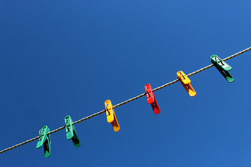 Clothespins on the sky background