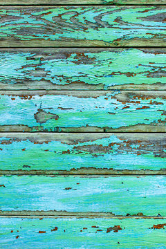 Old wooden board with peeling blue and green paint. Abstract background