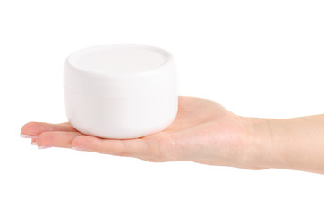 White jar of cream for a body in hands on a white background isolation
