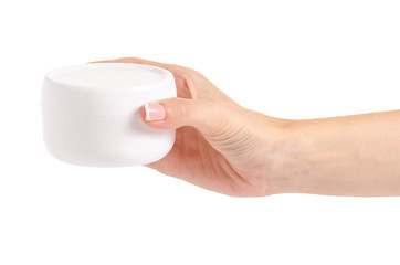 White jar of cream for a body in hands on a white background isolation