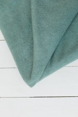 Angora fabric mint color. Angora fabric for clothes. fabric on white background