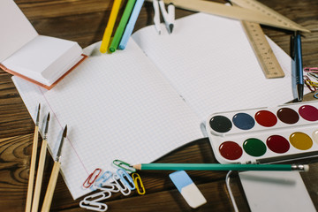 School supplies on a wooden desk . Realistic illustration.