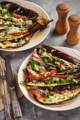 Roasted eggplant fan with mozzarella, tomatoes and parsley.