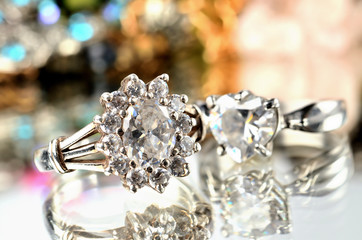 Silver ring with artificial stone and another ring in background - jewelery, warm color balance