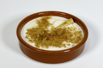 Dish of rice pudding with grated cinnamon.