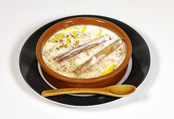 Dish of rice pudding with grated cinnamon.