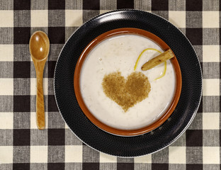 Dish of rice pudding with grated cinnamon.