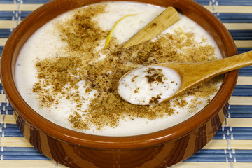 Dish of rice pudding with grated cinnamon.