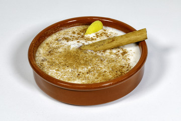 Dish of rice pudding with grated cinnamon.