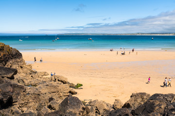 People enjoying Porthminster Beach, St Ives, on a hot, sunny, summer day.
