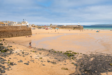 St Ives beach at low tide, in the evening on a Summer's day.