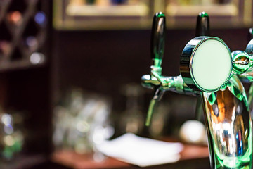 Chrome beer tap in modern bar