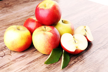 Ripe red apples on wooden background summer concept