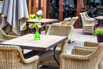 Outdoor restaurant interior with wicker chairs