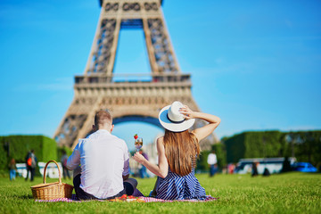 Couple having picnic near the Eiffel tower in Paris