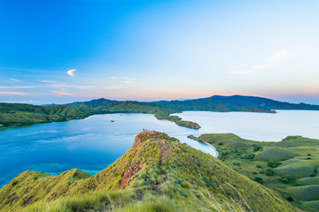 View from top of Gili Lawa before sunrise in the morning with clear blue sea and tourist, Komodo Island (Komodo National Park), Labuan Bajo, Flores, Indonesia - obrazy, fototapety, plakaty