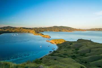 View from top of Gili Lawa in the morning with clear blue sea and tourist boats, Komodo Island (Komodo National Park), Labuan Bajo, Flores, Indonesia