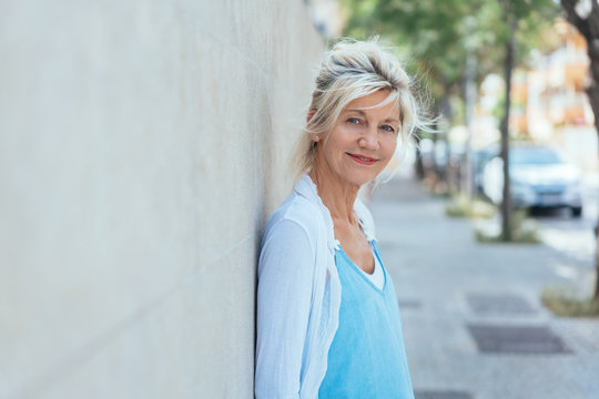 Street portrait of mature smiling blonde woman