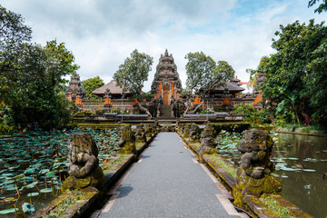Beautiful symmetrical view of Pura Taman Saraswati or Saraswati Temple surrounded by lotus pond and...