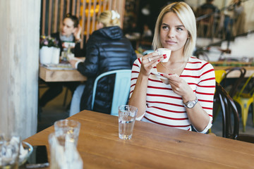 Beautiful woman drinking coffee in cafe