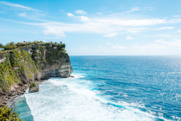 View of the cliff with waves in the sea from The Hindu Temple Pura Luhur Uluwatu, Pecatu, South Kuta, Badung Regency, Bali, Indonesia