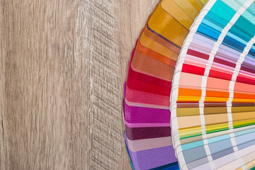 Colour swatches in fan on wooden background