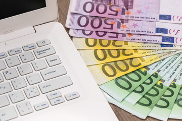 euro bilsl on white keyboard  laptop, close up