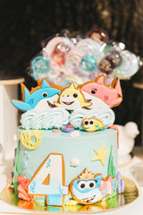 Obraz na płótnie Canvas Candy bar for your birthday. Children's party in the nature. Beautiful cake with fish, candy and number 4